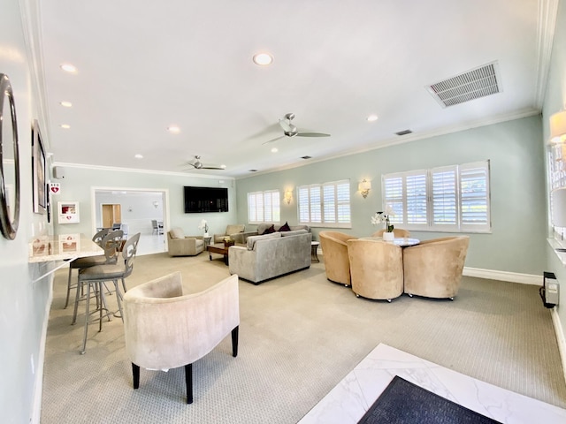 carpeted living room featuring ornamental molding and ceiling fan