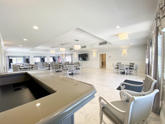 interior space featuring pendant lighting and a tray ceiling