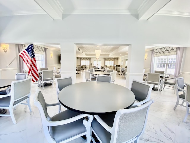 dining space featuring crown molding and beamed ceiling