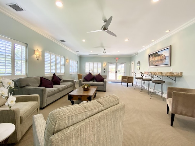 carpeted living room featuring crown molding and ceiling fan