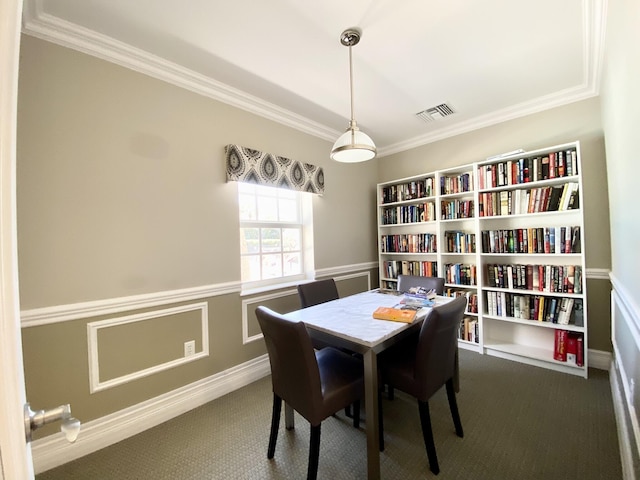 carpeted dining area featuring ornamental molding