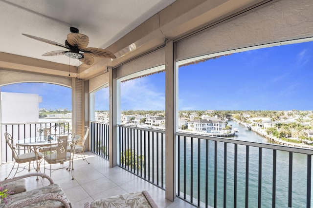 balcony with a water view and ceiling fan