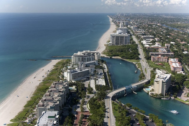 drone / aerial view with a water view and a beach view