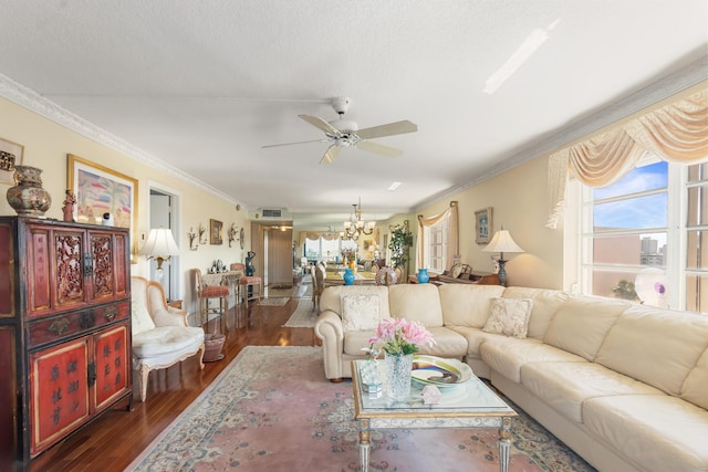 living room with crown molding, dark hardwood / wood-style flooring, and ceiling fan with notable chandelier