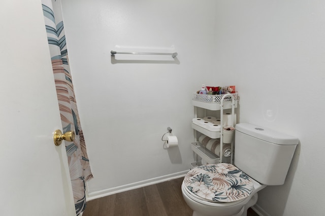 bathroom featuring hardwood / wood-style flooring and toilet