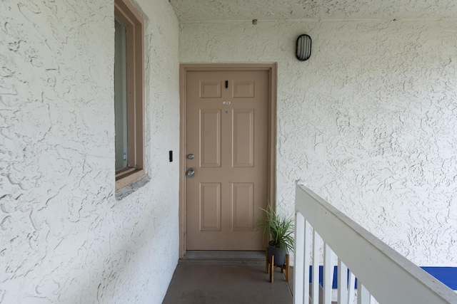 entrance to property with a balcony