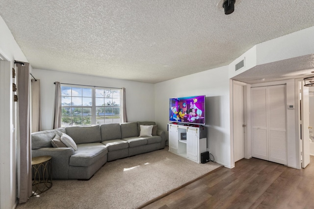 living room featuring hardwood / wood-style floors and a textured ceiling