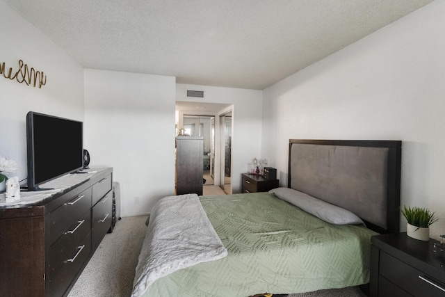 carpeted bedroom featuring a textured ceiling