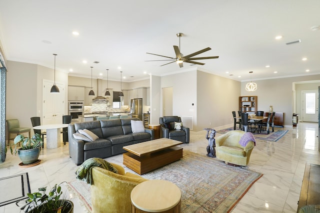 living room with crown molding and ceiling fan