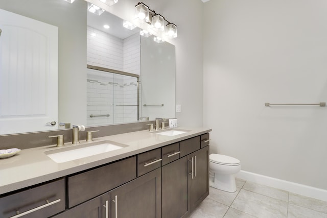 bathroom featuring tile patterned flooring, vanity, an enclosed shower, and toilet