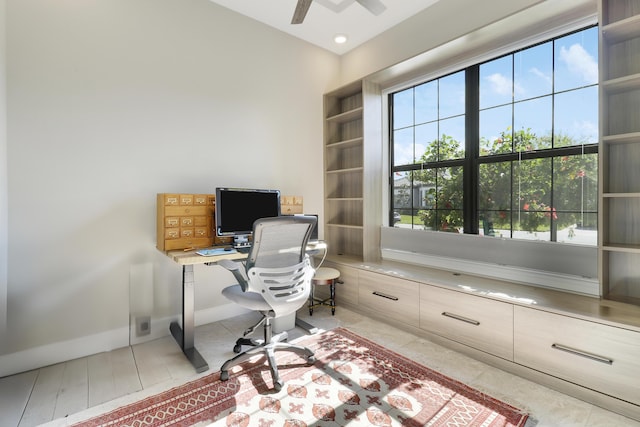 tiled office space featuring ceiling fan