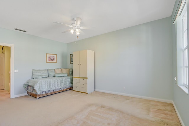 bedroom featuring light carpet and ceiling fan