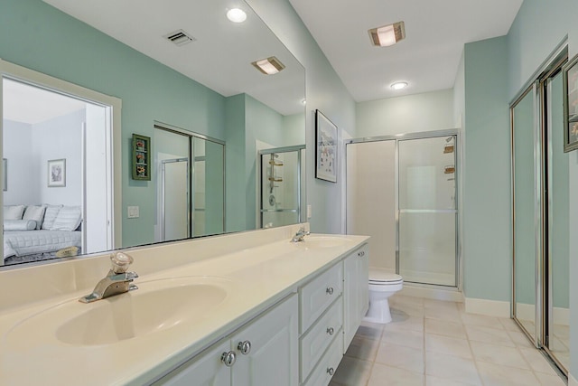 bathroom featuring tile patterned floors, toilet, an enclosed shower, and vanity