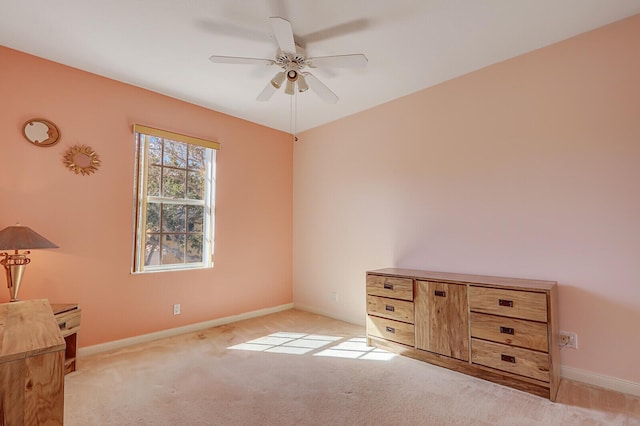 unfurnished bedroom featuring light carpet and ceiling fan