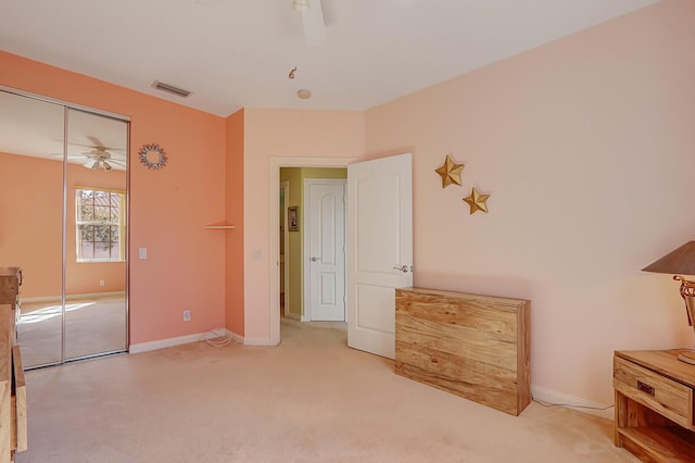 unfurnished bedroom featuring ceiling fan, carpet flooring, and a closet