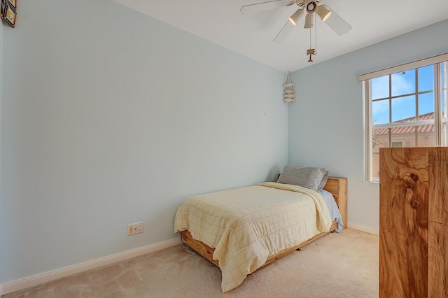 bedroom with light colored carpet and ceiling fan