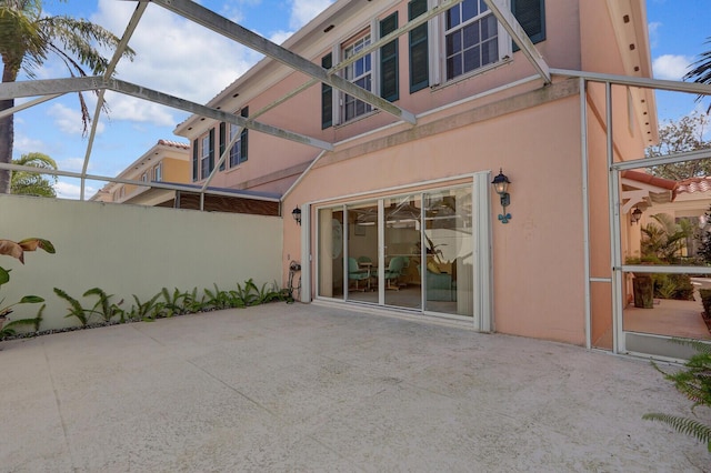 back of property with a lanai and a patio area