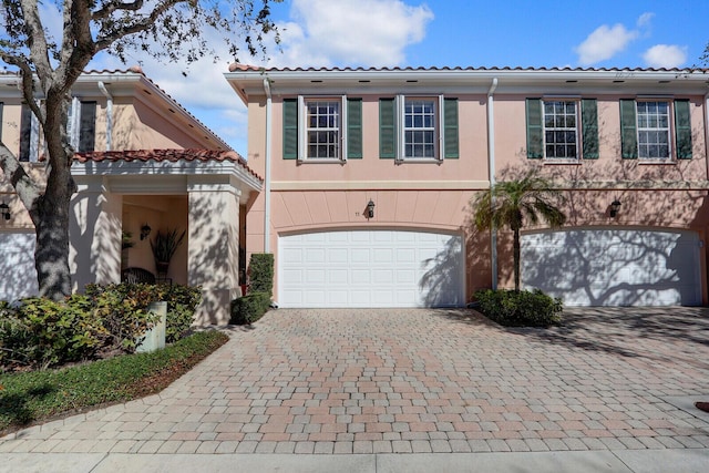 mediterranean / spanish-style home with a garage