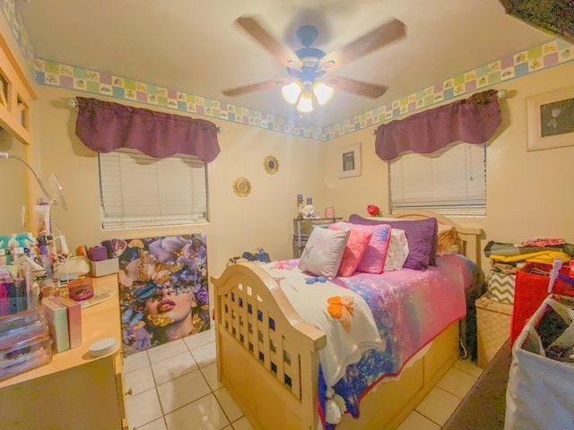 tiled bedroom featuring ceiling fan