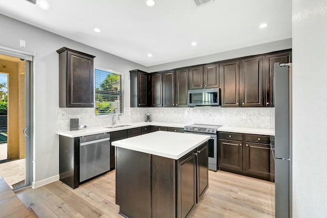 kitchen featuring dark brown cabinetry, sink, and appliances with stainless steel finishes