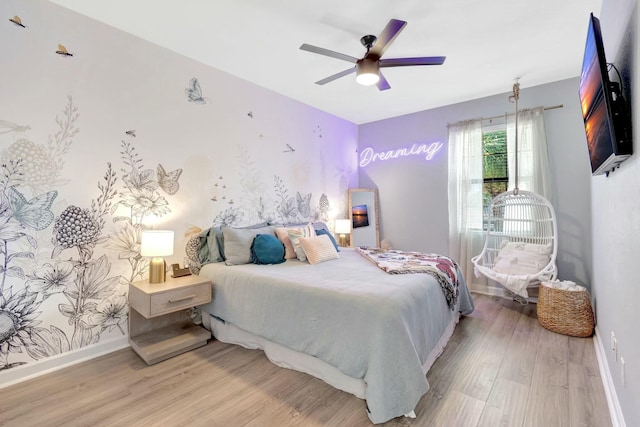 bedroom with ceiling fan and light hardwood / wood-style flooring