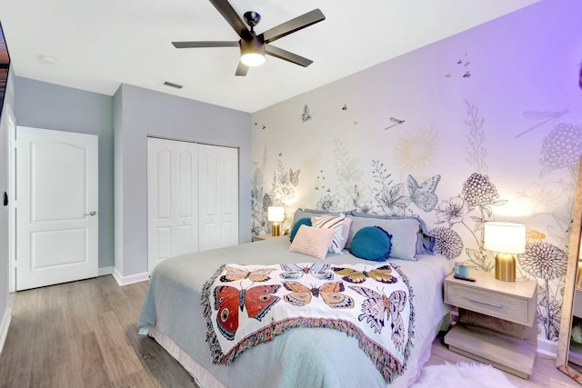 bedroom featuring ceiling fan, light wood-type flooring, and a closet