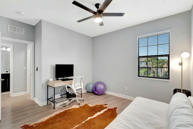 home office with ceiling fan and light hardwood / wood-style floors