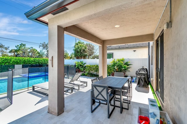 view of patio / terrace with a fenced in pool