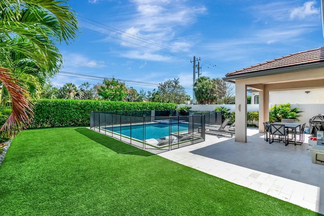 view of pool featuring a yard and a patio