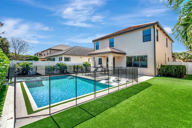 view of swimming pool featuring a patio area and a lawn