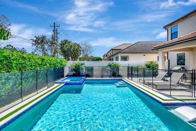 view of pool featuring an in ground hot tub and a patio