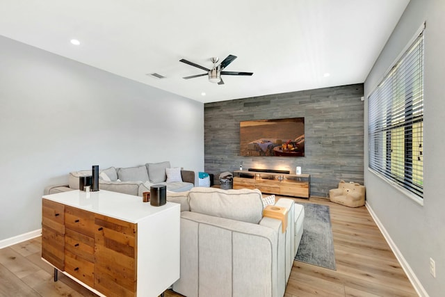 living room with ceiling fan and light hardwood / wood-style floors