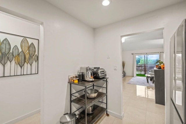 hall with light tile patterned flooring