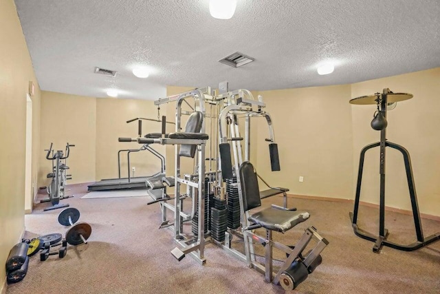 exercise room featuring a textured ceiling