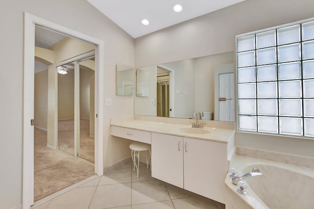 bathroom with vanity, a washtub, and tile patterned floors