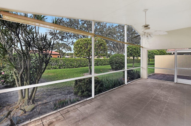 unfurnished sunroom featuring ceiling fan