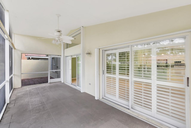 unfurnished sunroom featuring ceiling fan and lofted ceiling