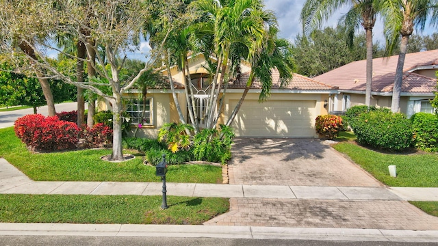 view of front facade featuring a garage and a front lawn