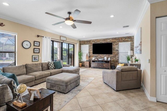 living room featuring ceiling fan, ornamental molding, a textured ceiling, and light tile patterned floors