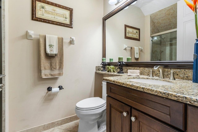 bathroom featuring tile patterned flooring, vanity, a shower with shower door, and toilet