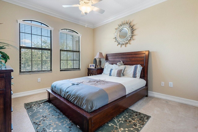 bedroom featuring ornamental molding, ceiling fan, and carpet