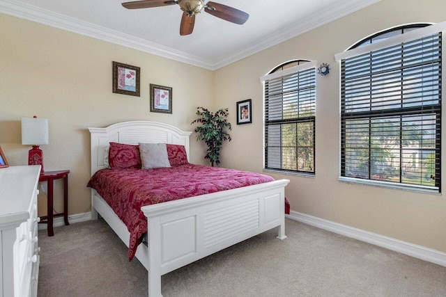 bedroom with crown molding, ceiling fan, and light carpet