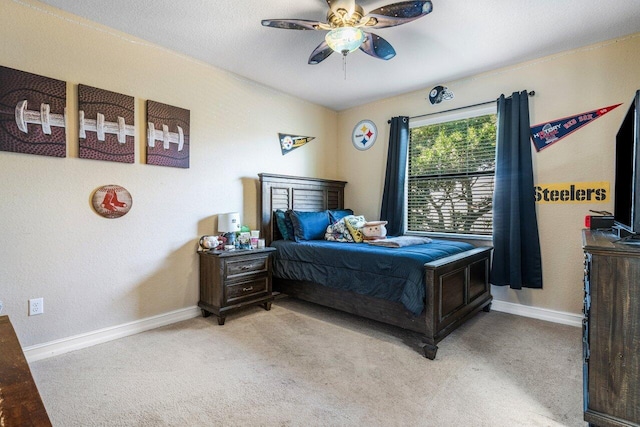 bedroom with light carpet and ceiling fan