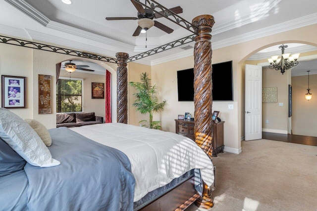 carpeted bedroom with ornamental molding, a tray ceiling, and ceiling fan with notable chandelier