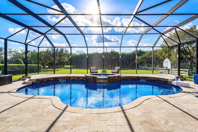 view of pool featuring a patio area, an in ground hot tub, a lawn, and glass enclosure