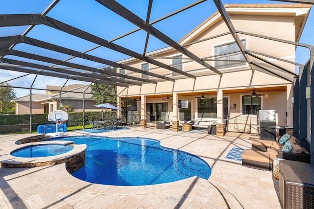 view of swimming pool featuring a patio, outdoor lounge area, an in ground hot tub, glass enclosure, and ceiling fan