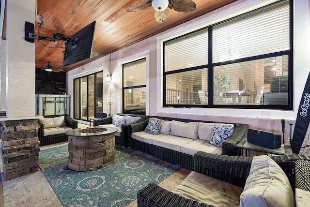 view of patio / terrace with an outdoor living space with a fire pit and ceiling fan