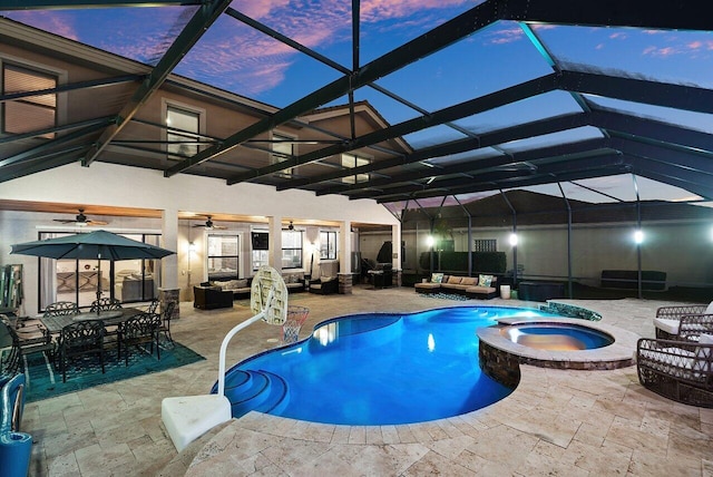 pool at dusk featuring an in ground hot tub, an outdoor hangout area, a patio, and a lanai