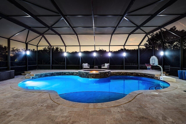 view of swimming pool featuring an in ground hot tub, a lanai, and a patio area