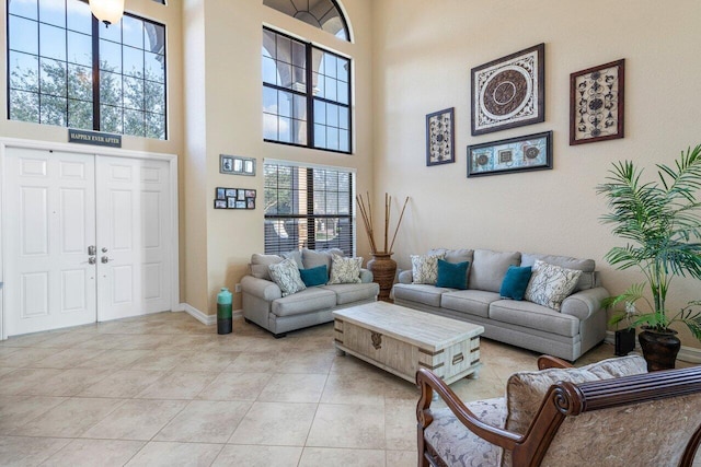 living room featuring a high ceiling and light tile patterned floors